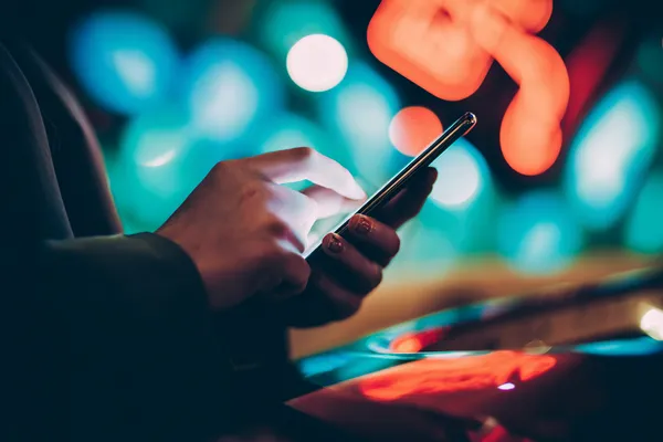 A glamorous woman holding casino chips in a neon-lit environment, representing the premium online casino atmosphere of SZ777.