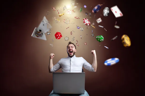 A woman smiling while playing online games on her laptop, surrounded by neon casino elements, showcasing SZ777’s diverse game collection.