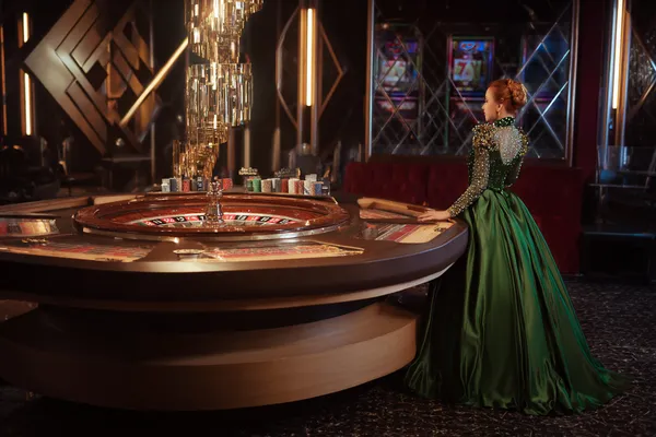 A man celebrating a winning moment on his laptop while gaming symbols float around him, capturing the excitement of SZ777 games.